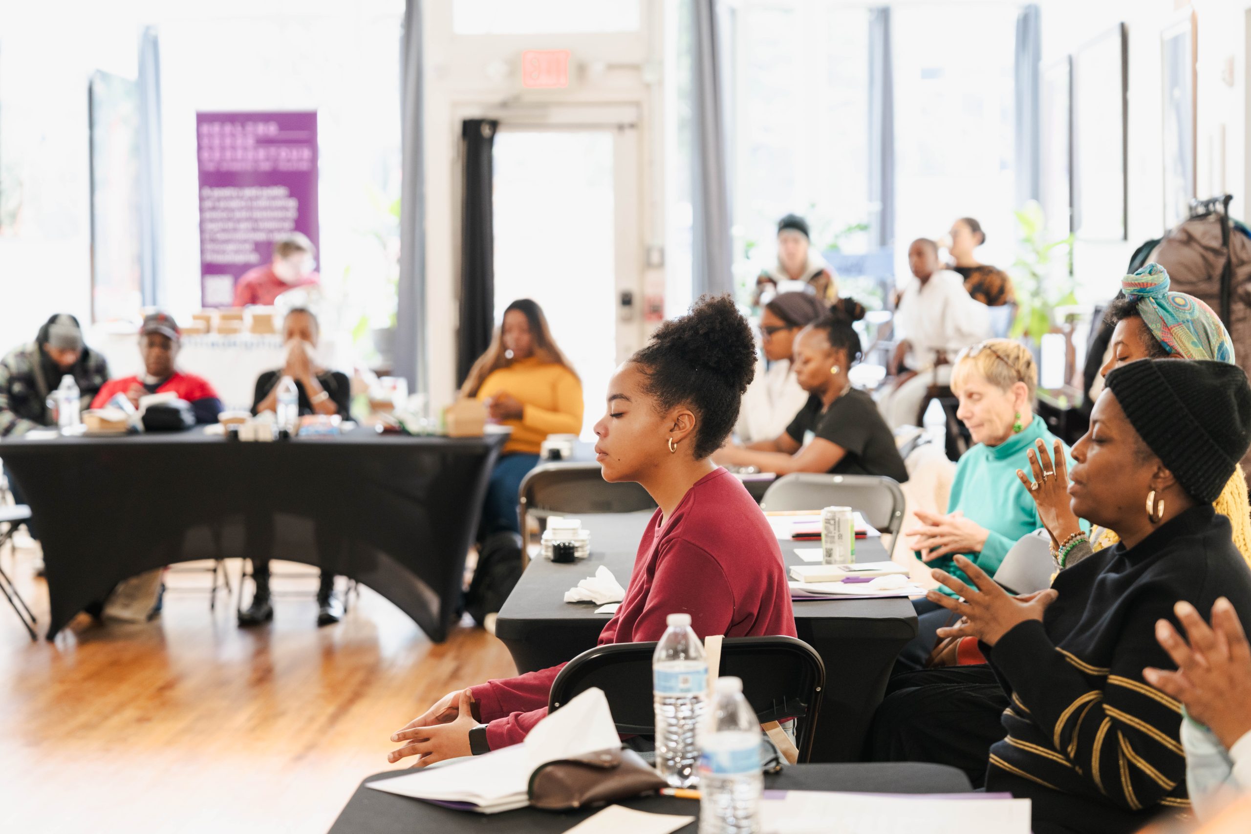 Workshop attendees meditates during grounding activity at a poetry workshop at Ubuntu Fine Art. Photo courtesy Steven CW Taylor.