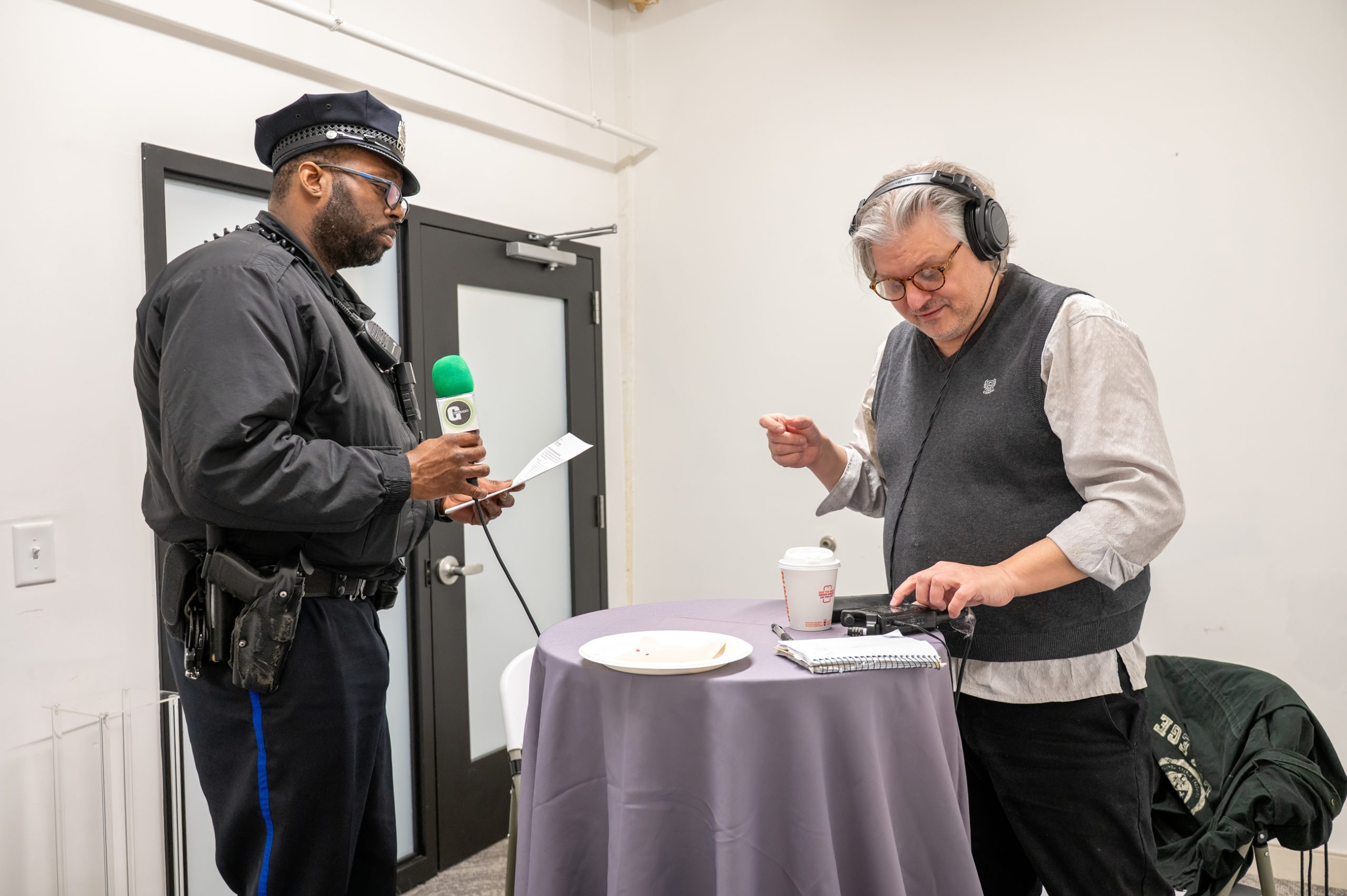 Police Officer records a poem with Tom Casetta of G-Town Radio for the Healing Verse Poetry Line. Photo courtesy Andrianna Ortiz / Embassy Interactive.